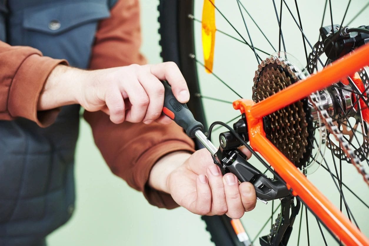 A person is using an orange bicycle tire.