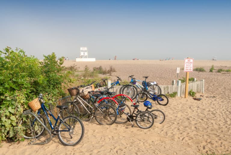 Parked bike rentals on Nantucket beach in summer.